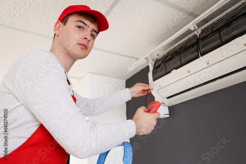 Male technician fixing air ...