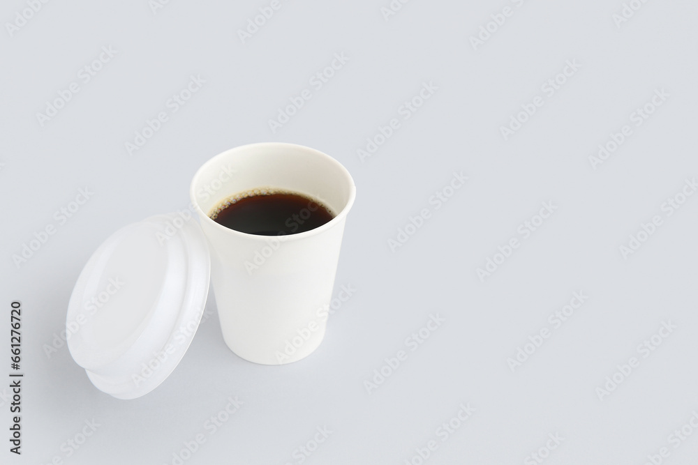 Takeaway paper cup of tasty coffee on white background