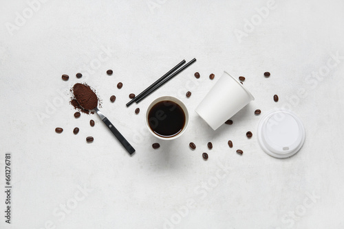 Composition with takeaway paper cup of tasty coffee, beans and straws on white background
