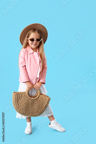 Stylish little girl with ba...