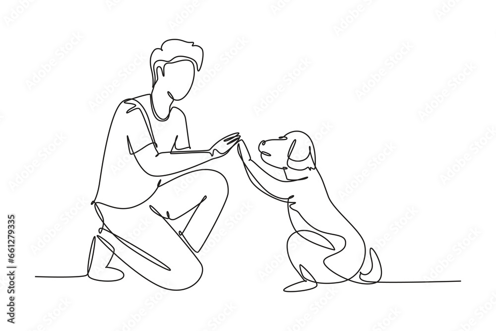 Single one line drawing of young happy boy giving high five gesture to his puppy dog at outfield park. Pet care and friendship concept. Modern continuous line draw design graphic vector illustration