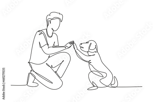 Single one line drawing of young happy boy giving high five gesture to his puppy dog at outfield park. Pet care and friendship concept. Modern continuous line draw design graphic vector illustration
