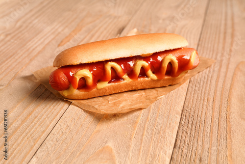 Tasty hot dog on wooden background