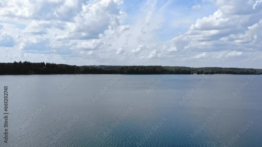 Jezioro Gwiazdy in Borowy Młyn, Pomeranian Voivodeship, Poland, filmed by a drone. The drone ascends above the lake's surface. Jezioro Gwiazdy in Borowy Młyn, Pomeranian Voivodeship, Poland, filmed by a drone. The drone ascends above the lake's surface.