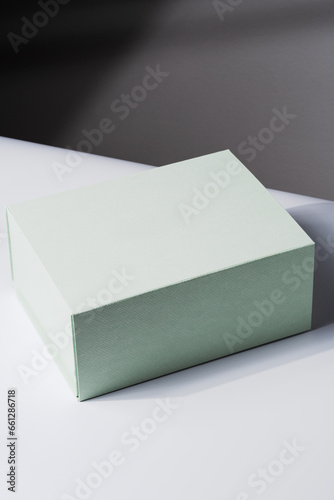 Square gift box, luxury shopping, mock up. White and gray background. Studio shot