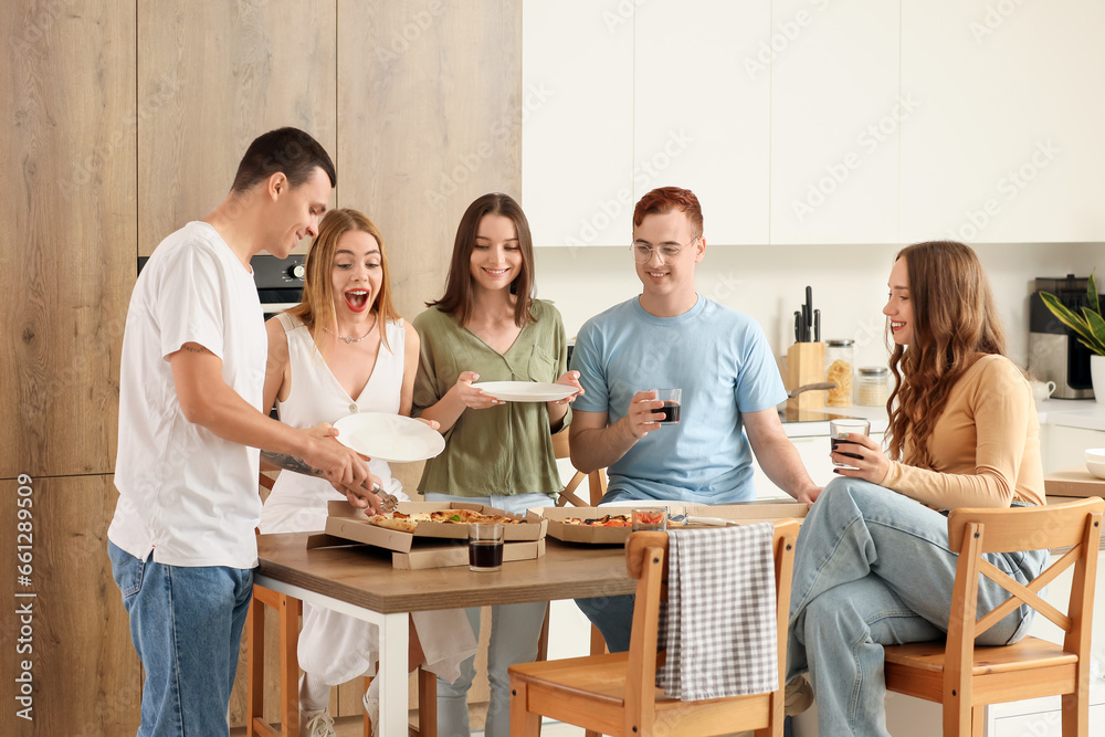 Group of young friends eating pizza at home party Group of young friends eating pizza at home party