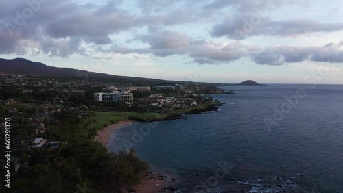 Low panning aerial shot of luxury beach resorts at Wailea during sunset in South Maui, Hawai'i. 4K photo