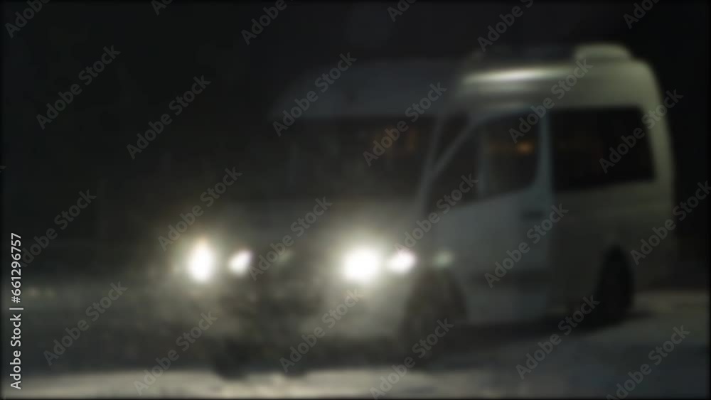 Lots of snow flakes against the backdrop of the minibus' headlights on at night in winter. Slippery road, danger of driving on the road at night in snowfall. Copy space for text Lots of snow flakes against the backdrop of the minibus' headlights on at night in winter. Slippery road, danger of driving on the road at night in snowfall. Copy space for text