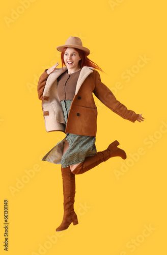 Jumping young woman in autu...
