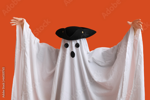 Woman in Halloween costume of ghost and pirate hat on color background