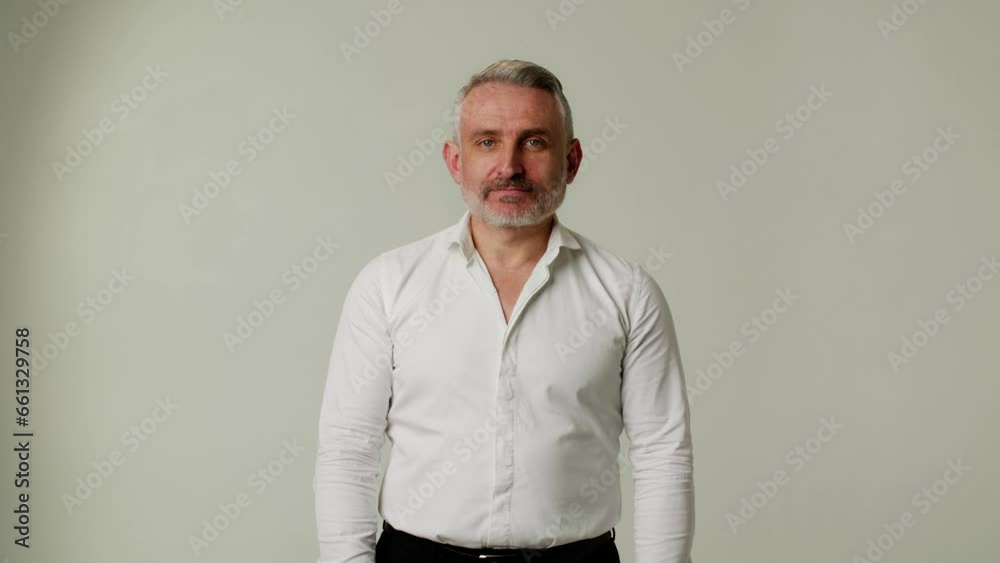 A middle aged man expresses doubts about the correctness of someone else advice. A businessman or boss questions the hasty conclusions of partner or subordinate. The demonstration of gesture of a A middle aged man expresses doubts about the correctness of someone else advice. A businessman or boss questions the hasty conclusions of partner or subordinate. The demonstration of gesture of a
