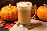 pumpkin spice latte in a tall glass with steam