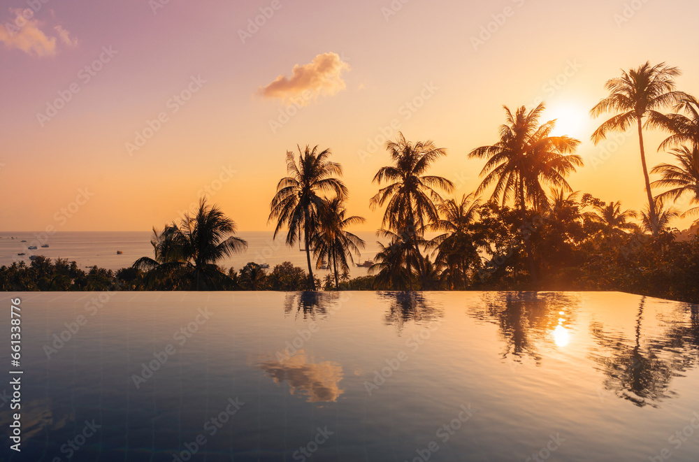 Sunny tropical landscape with reflections of palm trees in surface of water in pool on tropical paradise Koh Tao island during the colorful sunset Sunny tropical landscape with reflections of palm trees in surface of water in pool on tropical paradise Koh Tao island during the colorful sunset