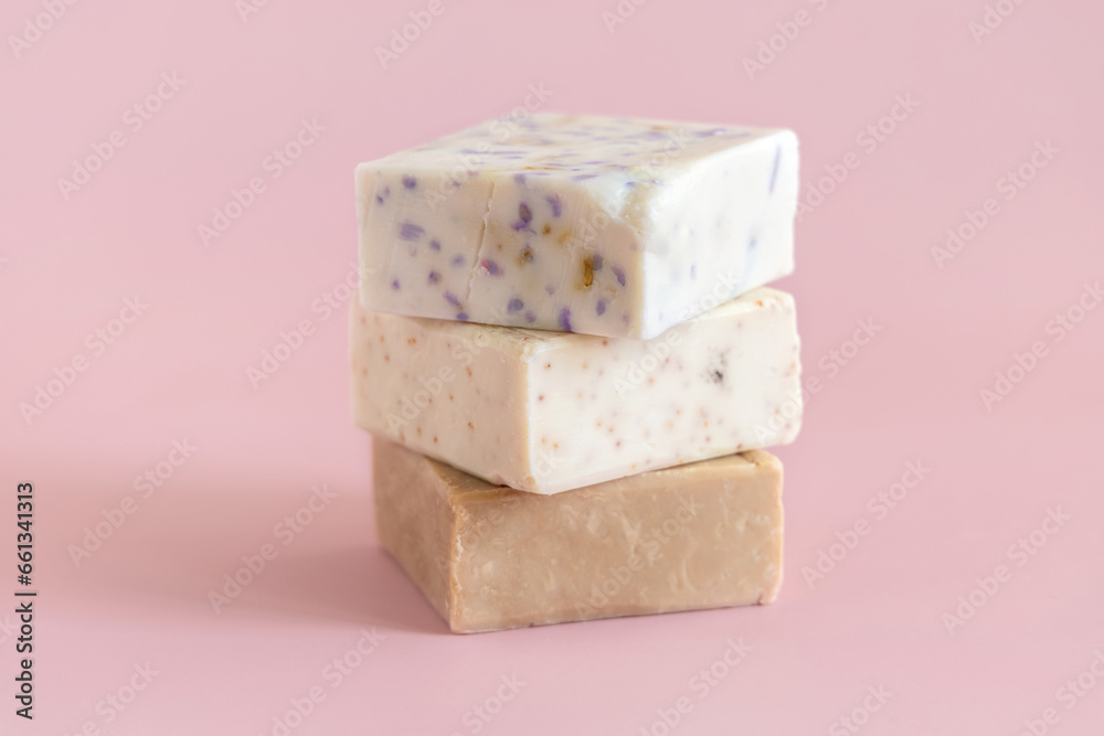 Beige handmade soap bars on light pink close up. Natural herbal product