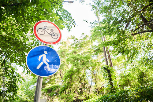 Bike and pedestrian signs in summer. Italy. View of a generic no cycling sign on a pedestrian footpath. The no cycling sign denotes that the use of bicycles, e-bicycles, scooters, e-scooters and