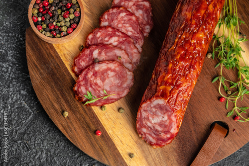 dry sausage sliced salami on a wooden board. banner, menu, recipe place for text, top view