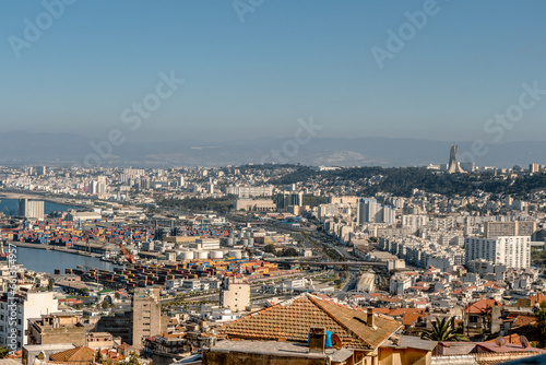 Alger, Algiers, Algeria, 10 07 2023 : Beautiful panorama of the bay of Algiers with the industrial port and the Maqam Echahid monument : Martyrs Monument, in the background. © Bruno