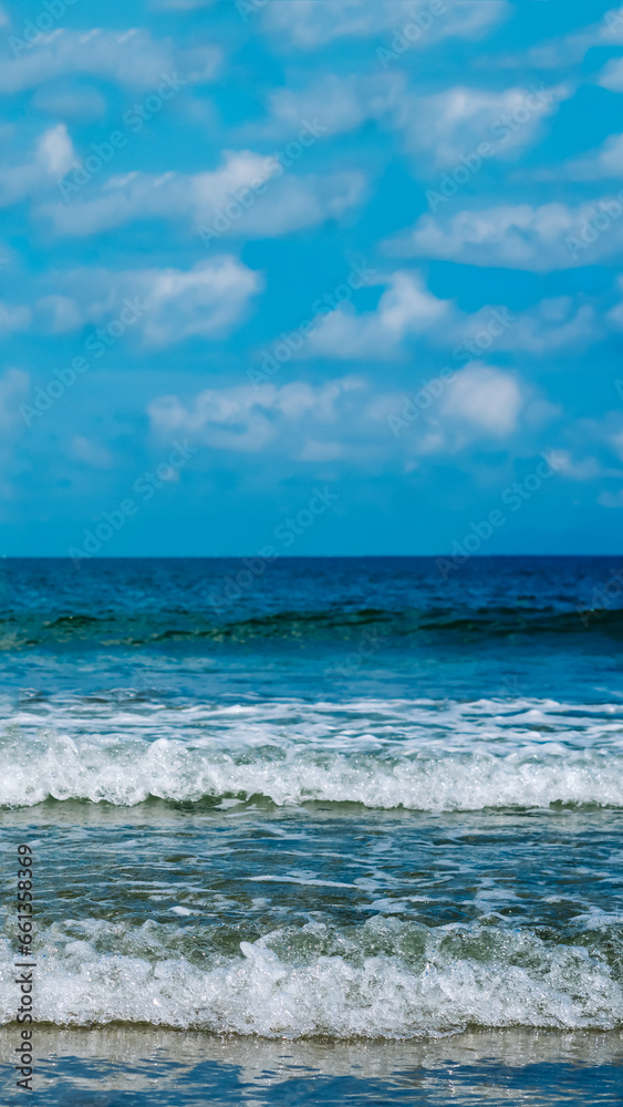 Turquoise clear sea view panorama blue sky white clouds close wave, beauty of nature, skyline. Vertical