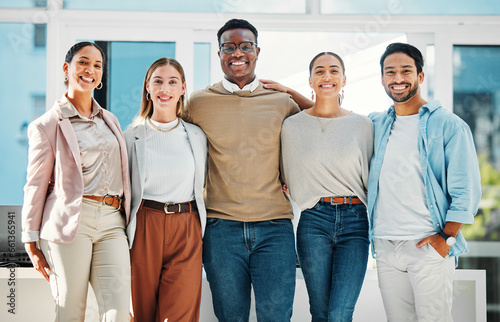 Portrait of confident business people with smile, hug and team at human resources office. Happy startup employees, men and women standing in workplace together with pride, solidarity and opportunity.