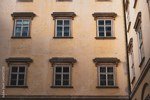 Vintage yellow building with various windows in Vienna, Austria