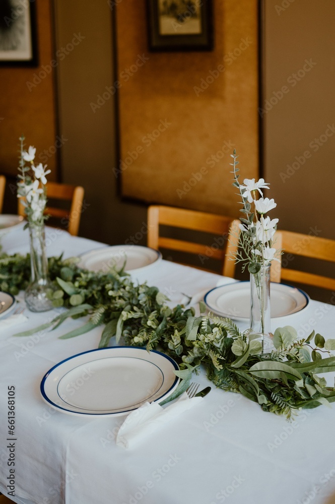 Romantic wedding rehearsal dinner setup with beautiful china and flowers