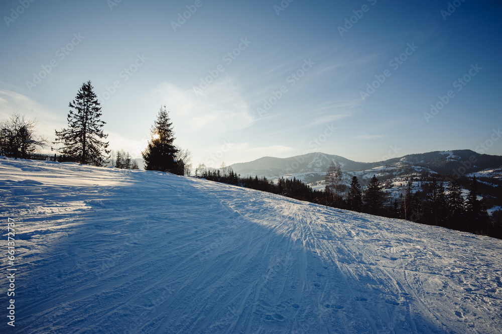 Winter mountain landscape. A steep mountain trail for skiers covered in snow.