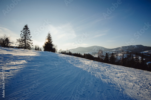 Winter mountain landscape. A steep mountain trail for skiers covered in snow. © Oleksandr