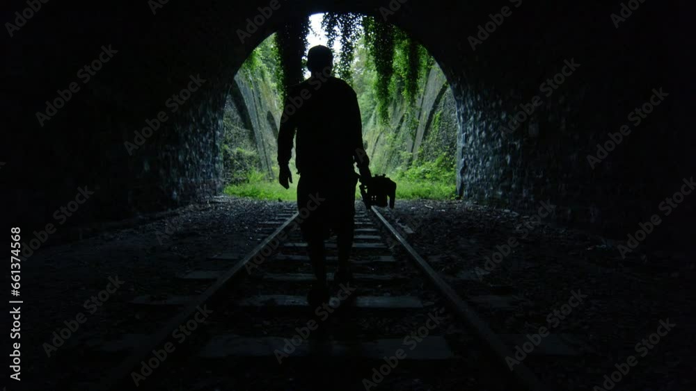 Silhouette of Man Walking Through Tunnel Of Silhouette of Man Walking Through Tunnel Of