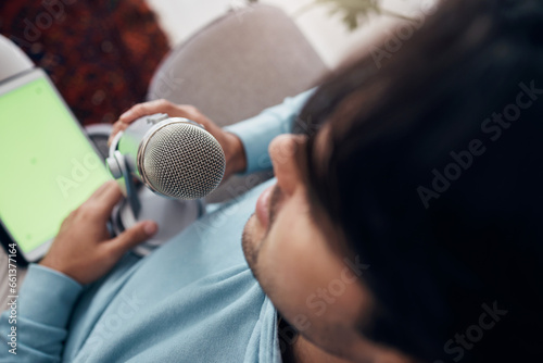 Man, microphone and green screen or tablet streaming for live audience, influencer or record. Male person, closeup or communication technology or speaker content creator, interview or voice for audio
