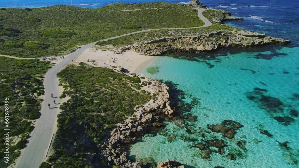 Aerial view of cyclists riding, in Salmon Bay, Rottnest Island, Australia- reverse, drone shot Aerial view of cyclists riding, in Salmon Bay, Rottnest Island, Australia- reverse, drone shot