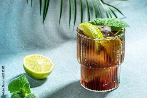 Canvas Print Alcohol cocktail cuba libre with rum, cola, mint and lime in the glass a light b