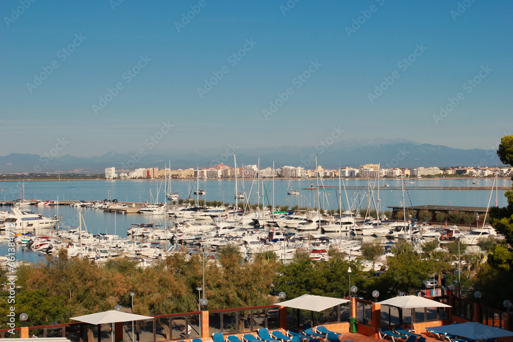 View of the port of Roses. In the distance the urban area. Roses is located on the Costa Brava and is one of the most visited places on the Spanish coast.