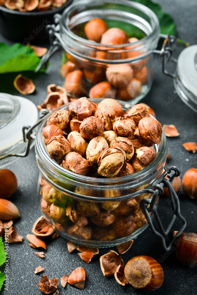 Organic shelled hazelnuts in a glass jar. Nut kernels. Close up.