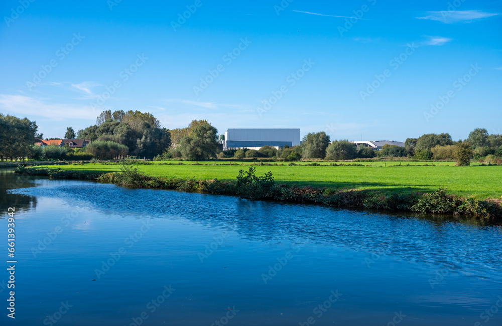 Industrial buidling reflecting in the water of the river Dender, Ninove, Flemish Region, Belgium Industrial buidling reflecting in the water of the river Dender, Ninove, Flemish Region, Belgium