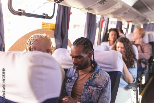 Group of people of different ages and ethnicities, inside a bus. Urban public transport concept.