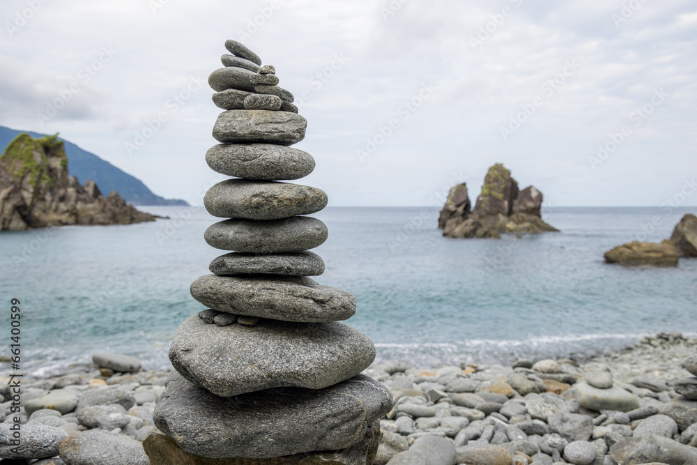 Fototapeta premium Pebble tower balance harmony stones over the stone beach