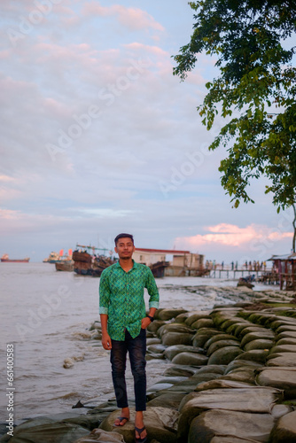 Portrait of south asian young boy in front of a river  photo