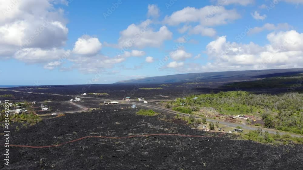 Kalapana community viewed from above with lava fields and volcano in the background, Hawaii Island