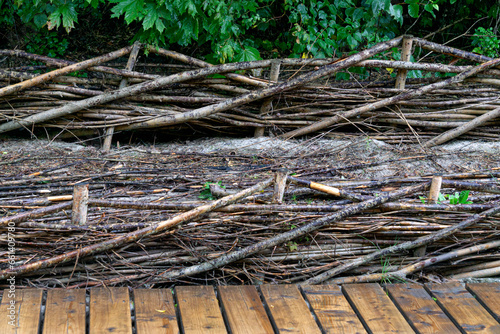 Layers of willow branches between wooden posts provide protection from wind and waves.