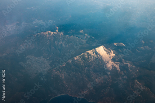 Panoramic view from airplane window of mountain landscape in Cyprus at dawn