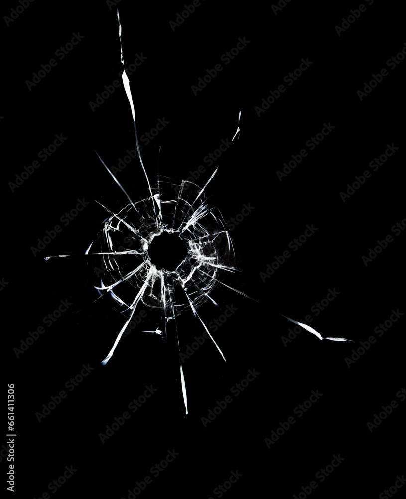 Fototapeta premium Cracked texture of broken glass on a black background.