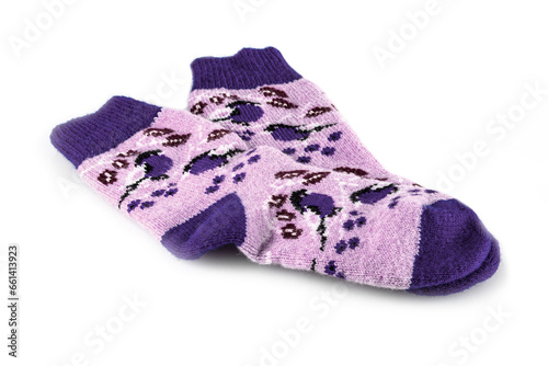 Pair of warm woolen winter socks with knitted decorations, on a white background. Socks for Christmas, holidays or cold winter.