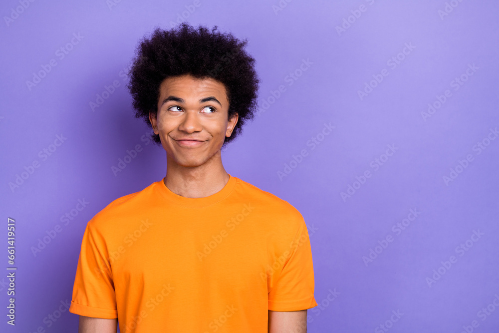 Portrait of positive minded person look interested empty space contemplate isolated on purple color background Portrait of positive minded person look interested empty space contemplate isolated on purple color background