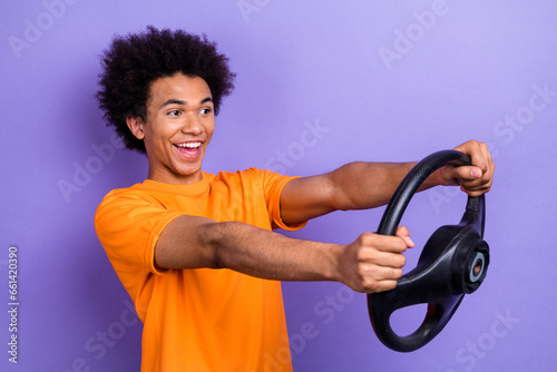 Photo of fast model guy funny chevelure riding his maserati automobile hold leather steering wheel isolated on purple color background photo