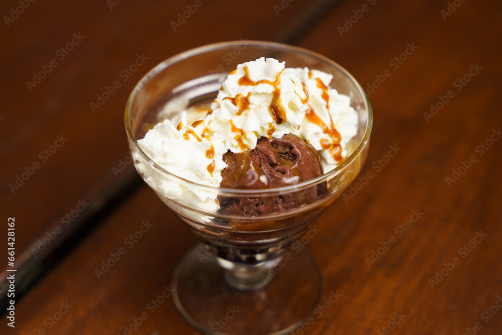 Chocolate and Vanilla Ice Cream with whipped cream on top with a bit of caramel Chocolate and Vanilla Ice Cream with whipped cream on top with a bit of caramel