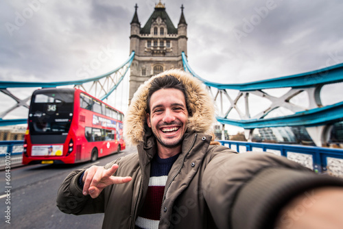 Photography Smiling man taking selfie picture in London, England - Young tourist male taking