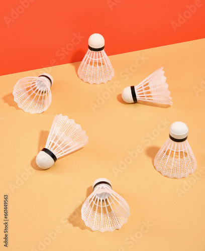 White badminton shuttlecocks scattered on the surface. Idea of sport.
