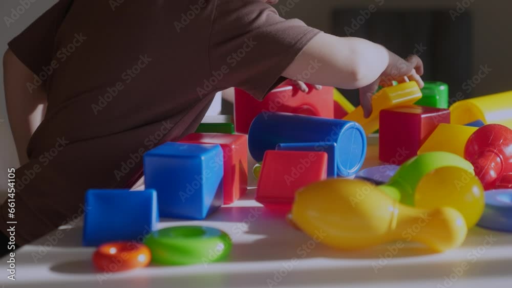 kindergarten close-up. a group of children play toys cubes and cars on the table in kindergarten. happy family preschool education concept. nursery indoor boy baby toddler home kindergarten close-up. a group of children play toys cubes and cars on the table in kindergarten. happy family preschool education concept. nursery indoor boy baby toddler home