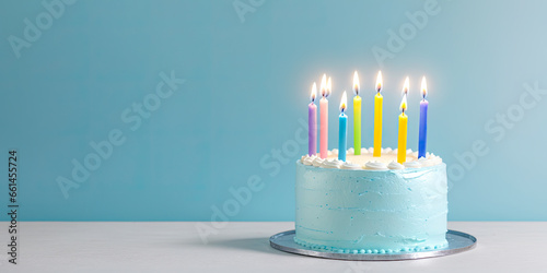 Celebration birthday cake and seven colorful birthday candles. blue background. Happy birthday concept. copy space