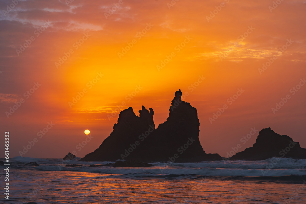 fiery summer sunset behind the typical rocks of benijio beach in the north east of tenerife island